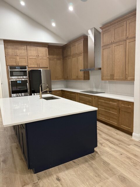 Modern kitchen featuring wooden cabinetry, quartz countertops, and a central island with a sink. Ideal for showcasing contemporary design and functionality.
